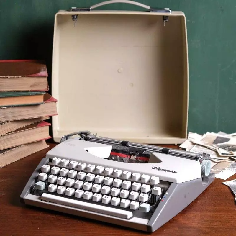 Vintage Olympia brand typewriter with bag.