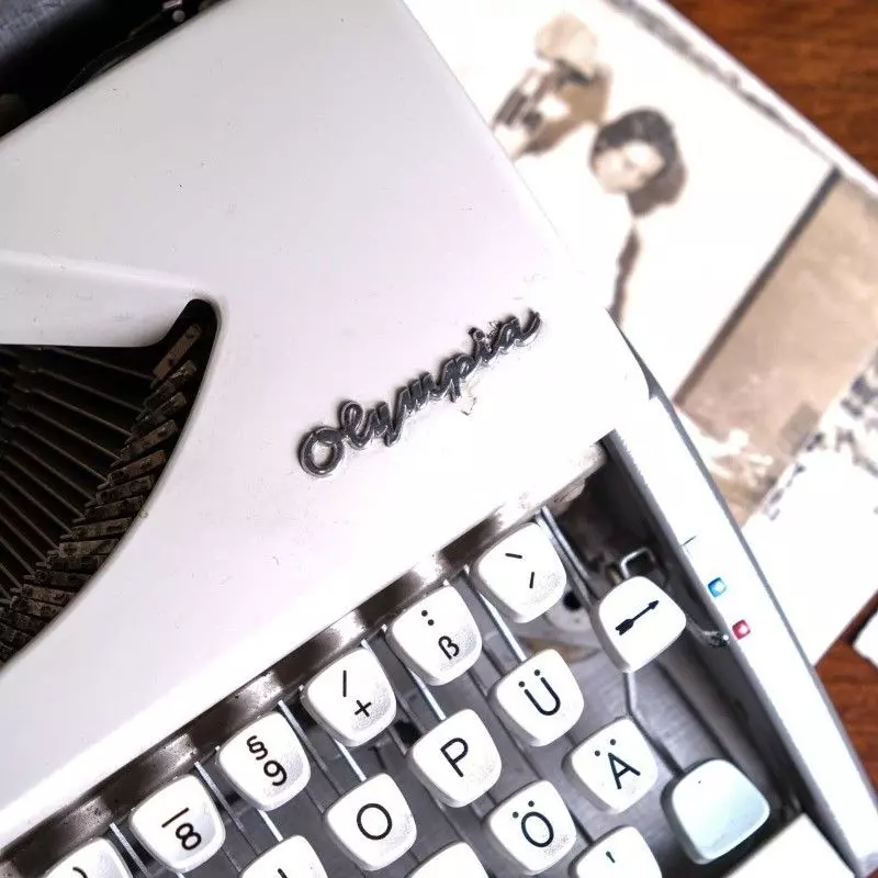 Vintage Olympia brand typewriter with bag.