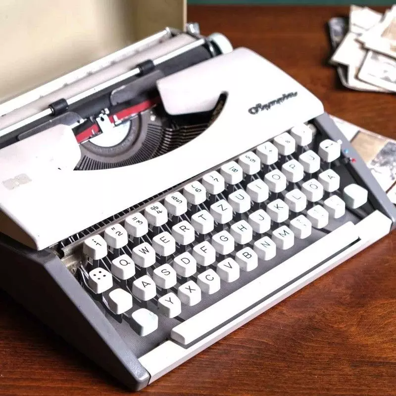 Vintage Olympia brand typewriter with bag.