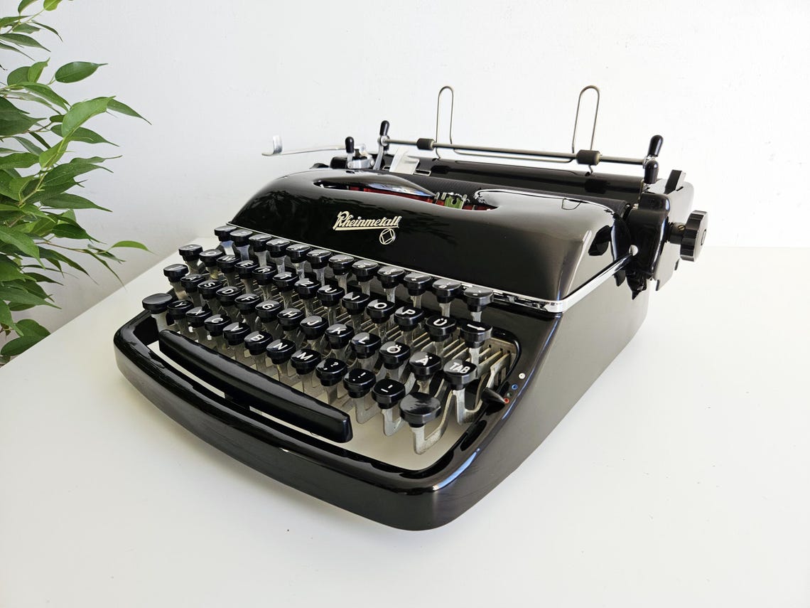 Rheinmetall KST Typewriter, original black color, from the 1950s. With original case. Collectible. Unusual gift.