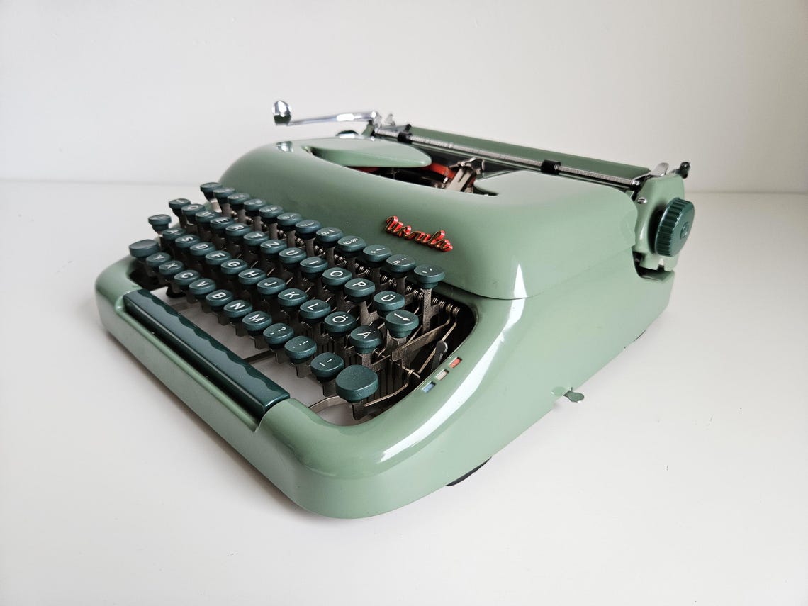 Green Ursula portable working vintage typewriter from the 1950s. With case, unusual gift