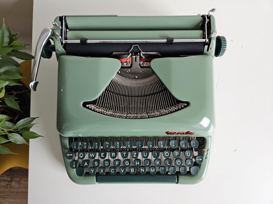 Green Ursula portable working vintage typewriter from the 1950s. With case, unusual gift